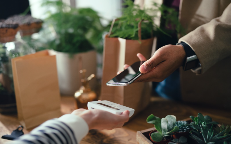 Customer making a contactless mobile payment at a retail checkout
